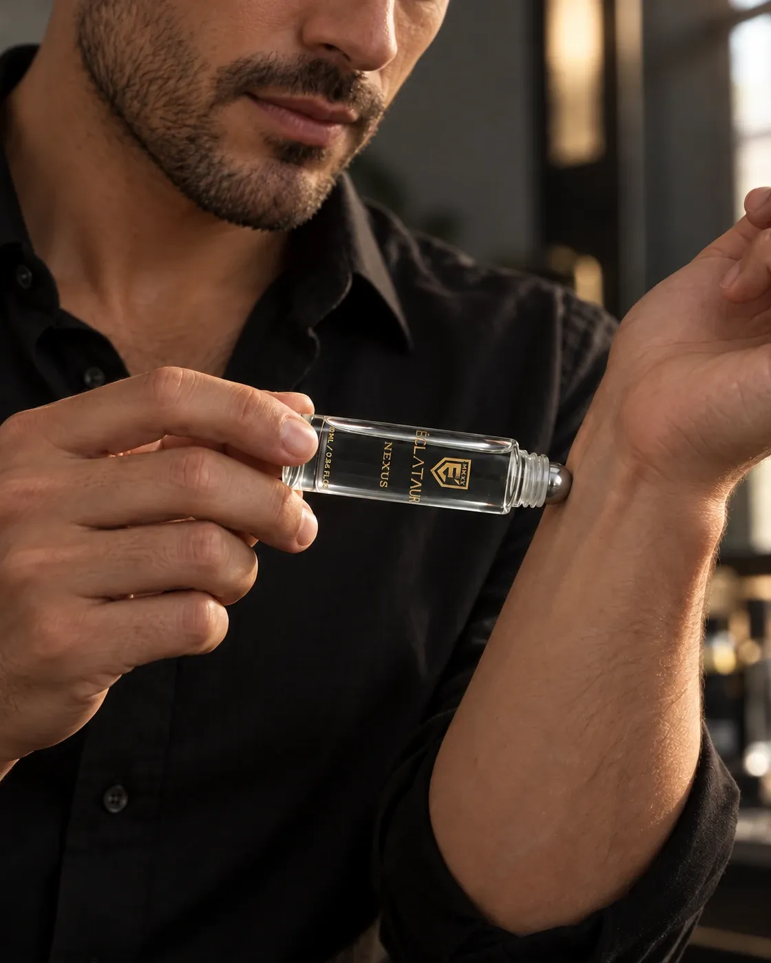 ÉCLATAUR NEXUS clear-liquid roll-on perfume oil applied to the wrist with a steel rollerball